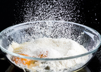 Add eggs and flour to a transparent bowl for making batter.