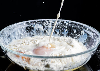 Add eggs and flour to a transparent bowl for making batter.