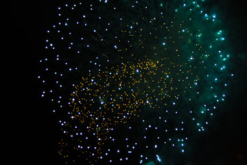 Star ball scattering bright yellow and green firework lights. during Halloween, Christmas, Independence Day, New Year.