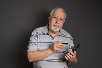 good-natured smiling man shows something on the tablet