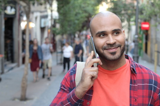 Ethnic Man Calling By Phone Outdoors 