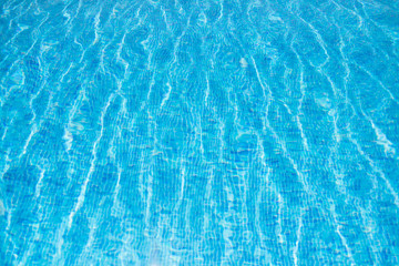 Blue swimming pool rippled water detail. Background