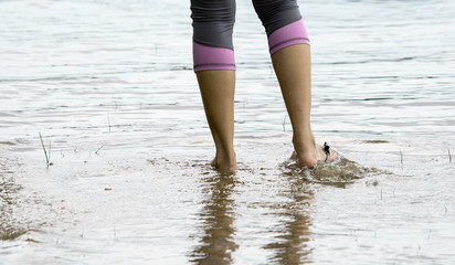 Female feet while walking in a beach