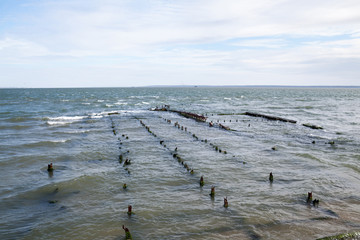 Remains of the old jetty in the sea.