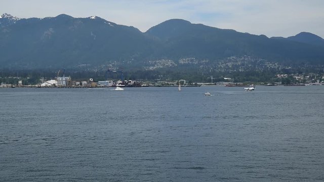 A seaplane is taking off from the sea.   Burrard Inlet Vancouver BC Canada
