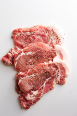 Fresh raw seasoned pork on white background 