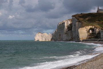 Etretat, France. A lonely church, standing on the edge of a deserted cliff of chalk cliffs on the...