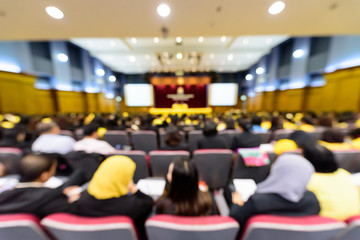 Blurred the big meeting room with many people.