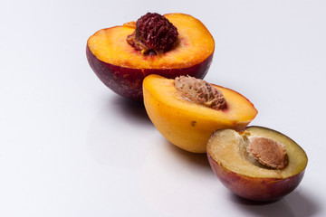 Nectarine, peach and plum - white background.