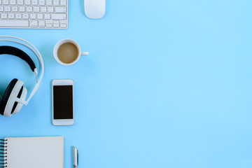 The office blue desk and equipment for working with coffee in top view and flat ray concept.