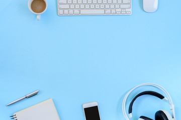The office blue desk and equipment for working with coffee in top view and flat ray concept.