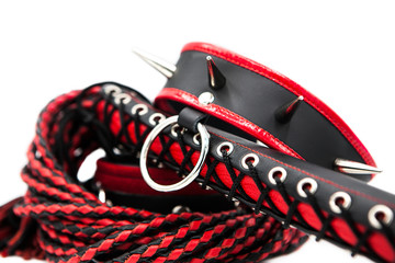 Sex toys for bdsm. Leather whip and collar with spikes isolated on white background