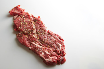 Fresh raw seasoned beef on white background 