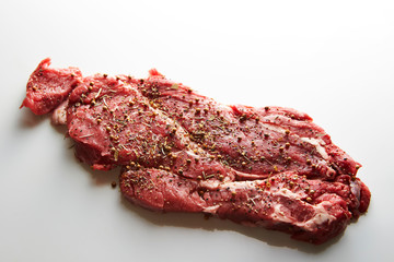 Fresh raw seasoned beef on white background 