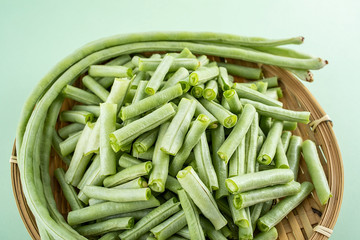 Fresh vegetables kidney beans on a light green background