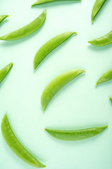 Fresh bean pod vegetable sweet bean poster background material on light green background