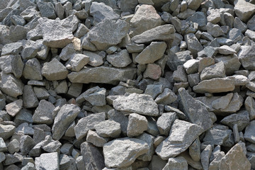 Gray textured surface of a heap of construction pebbles and gravel