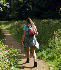 Woman is trekking with her little rucksack - 267383595