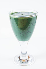 Banana and blueberry smoothie with spirulina in a glass