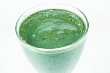 Banana and blueberry smoothie with spirulina in a glass