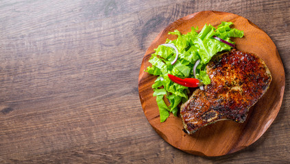 Pork Loin chops marinated meat Steak with vegetables slad on wooden table background
