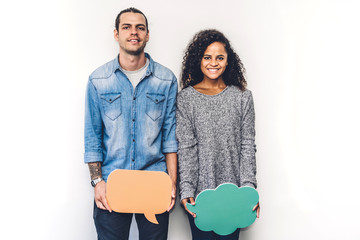 Two friends holding a speech bubble icon together