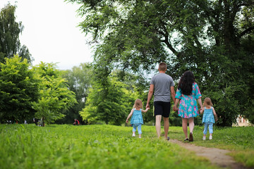 Fototapeta premium Mom with two daughters twins
