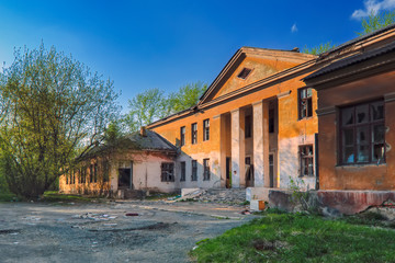 Old abandoned collapsing building. Landscape with the ruins of the old buildings.