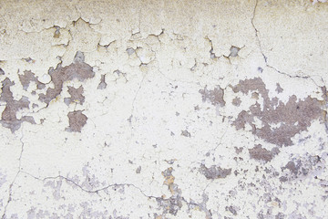 aged wall with cracked paint on it
