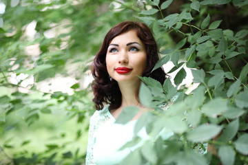 Fototapeta premium Beautiful girl in a spring leaf park