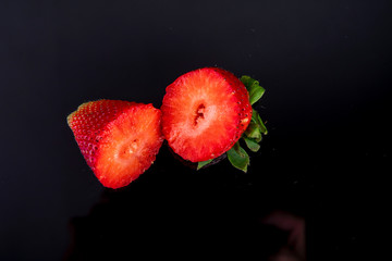 fresh strawberry rich in vitamins cut open on a dark background