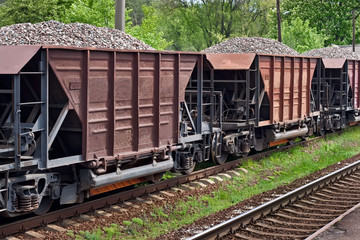 Fototapeta na wymiar Old freight train with gravel at country station