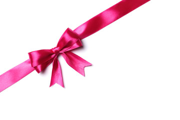 Pink bow and ribbon on a white background. The concept of gifts.