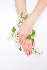 Obraz na płótnie Canvas Female hands with spring white lilac flowers