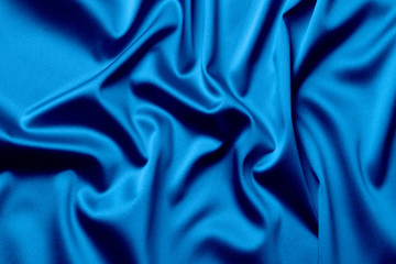 The texture of the satin fabric of blue color for the background