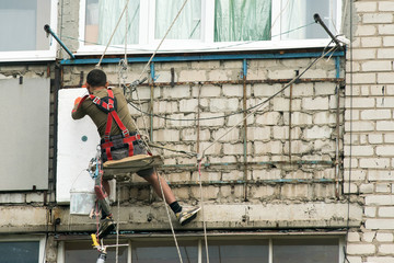 Thermal insulation of walls in the house foam in a high-rise building.