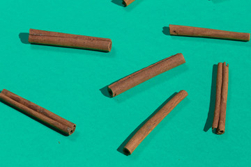 many raw cinnamon sticks, isolated on blue background, aromatic condiment. food,
