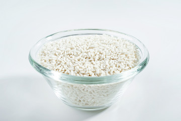 Glass bowl filled with a bowl of white glutinous rice on a white background