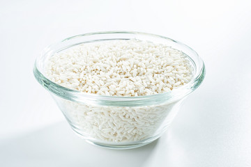 Glass bowl filled with a bowl of white glutinous rice on a white background