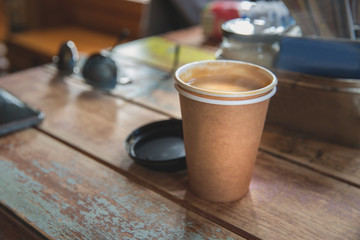 Take away coffee cup on wooden table