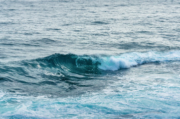 Close up of big ocean wave swirl with white foam