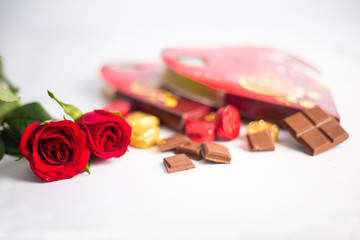 Chocolates Dry Fruits and Red Roses Scattered Background