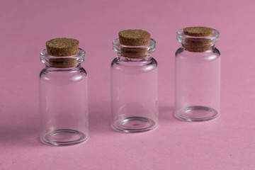 Empty glass medical pharmaceutical sterile bottles for injection on the red background. close up photo