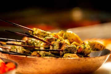 Grilled meat skewers with spices on sticks