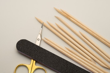 Manicure tools on a white background. Scissors, nail file, sticks, etc.
