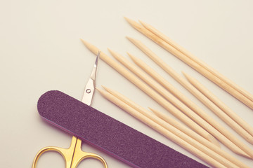 Manicure tools on a white background. Scissors, nail file, sticks, etc.