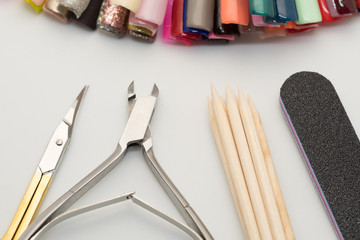 Manicure tools on a white background. Scissors, nail file, sticks, etc.