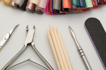 Manicure tools on a white background. Scissors, nail file, sticks, etc.