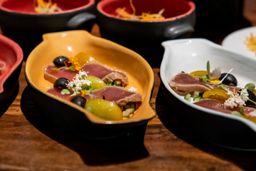 Smoked seared tuna with olives in buffet line