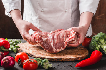 Hands Chef Butcher holdind pork meat on kitchen, cooking food